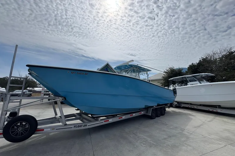 Slide: The Image of 2016 Freeman 37VH boat on trailer under cloudy sky. - 3