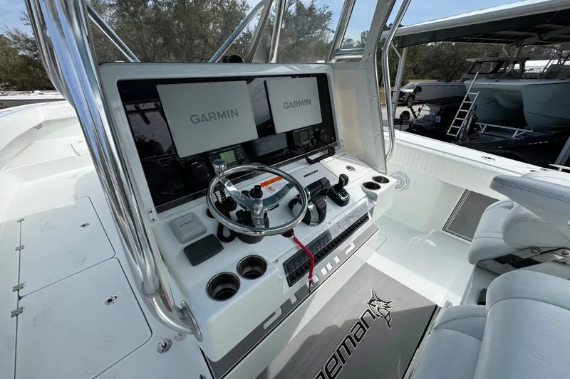 Slide: The Image of 2016 Freeman 37VH boat cockpit with Garmin navigation system and steering wheel. - 31