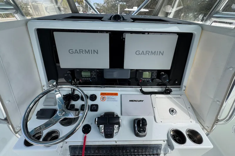 Slide: The Image of Freeman 37VH 2016 boat dashboard with Garmin displays and Mercury controls. - 32