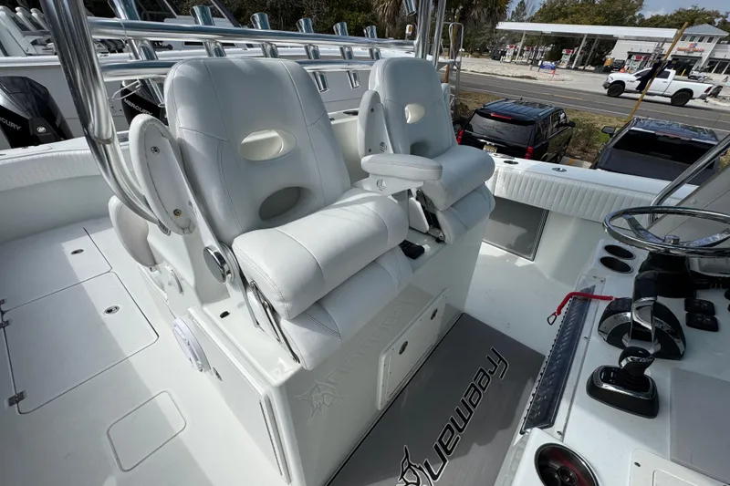 Slide: The Image of Luxury seating on a 2016 Freeman 37VH boat, featuring white cushioned captain chairs. - 35