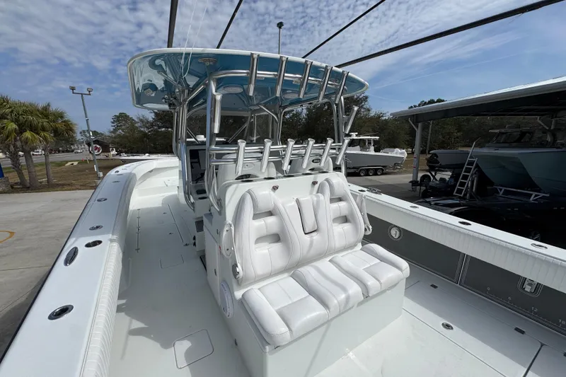 Slide: The Image of 2016 Freeman 37VH boat with white seating and sleek design, docked outdoors. - 36