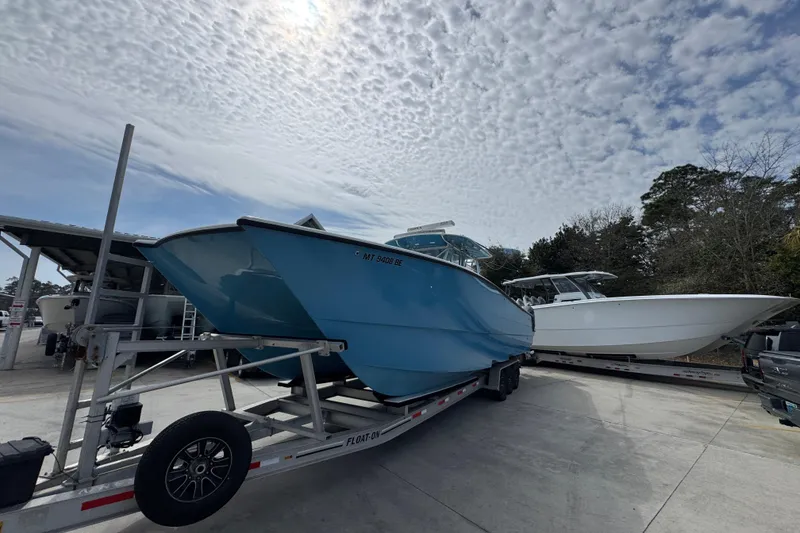 Slide: The Image of 2016 Freeman 37VH boat on trailer under cloudy sky. - 4