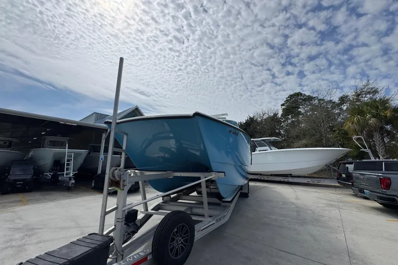 Slide: The Image of 2016 Freeman 37VH boat on trailer under cloudy sky at marina. - 5