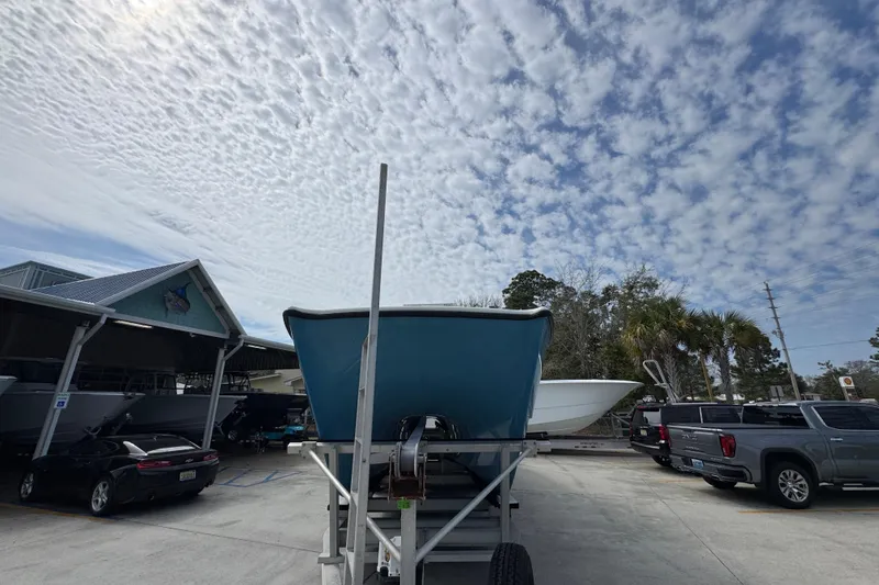 Slide: The Image of 2016 Freeman 37VH boat on trailer under cloudy sky at marina. - 6