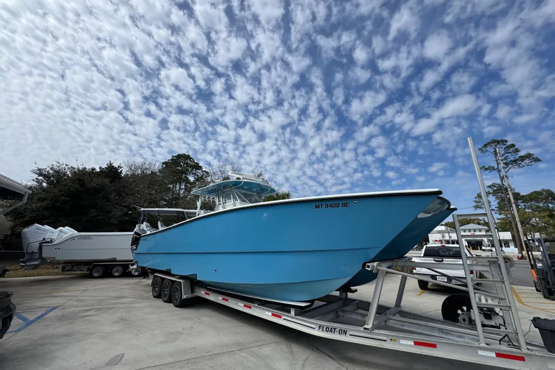 Slide: The Image of Blue 2016 Freeman 37VH boat on trailer under cloudy sky. - 8