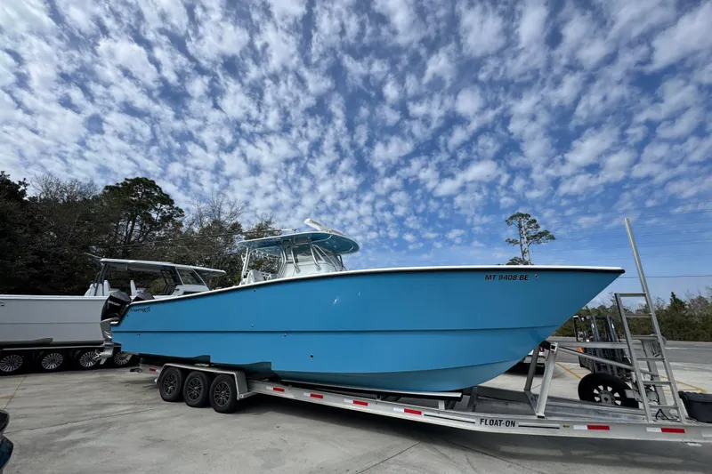 Slide: The Image of 2016 Freeman 37VH boat on trailer under cloudy sky. - 9