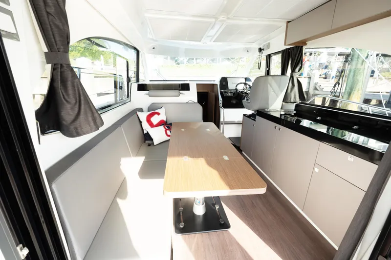 Slide: The Image of Interior of 2022 Beneteau Antares 11 Coupe, featuring modern seating and dining area. - 10