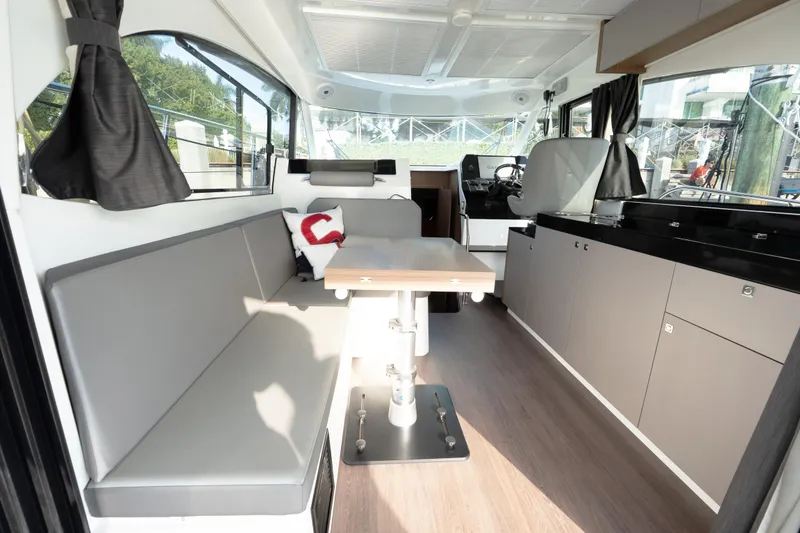 Slide: The Image of Interior of 2022 Beneteau Antares 11 Coupe, featuring modern seating and sleek cabinetry. - 11