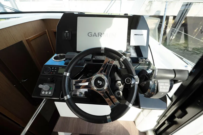 Slide: The Image of 2022 Beneteau Antares 11 Coupe helm with Garmin navigation and Mercury controls. - 14
