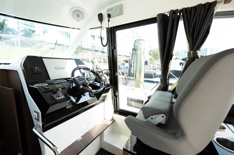 Slide: The Image of Interior helm of 2022 Beneteau Antares 11 Coupe with modern controls and seating. - 16
