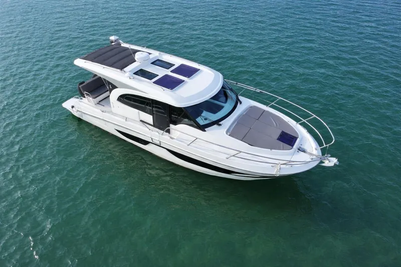 Slide: The Image of 2022 Beneteau Antares 11 Coupe boat on calm blue water. - 5