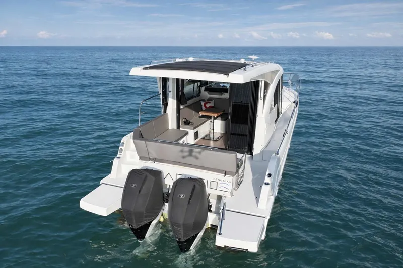 Slide: The Image of 2022 Beneteau Antares 11 Coupe boat on open water, rear view with twin engines. - 8