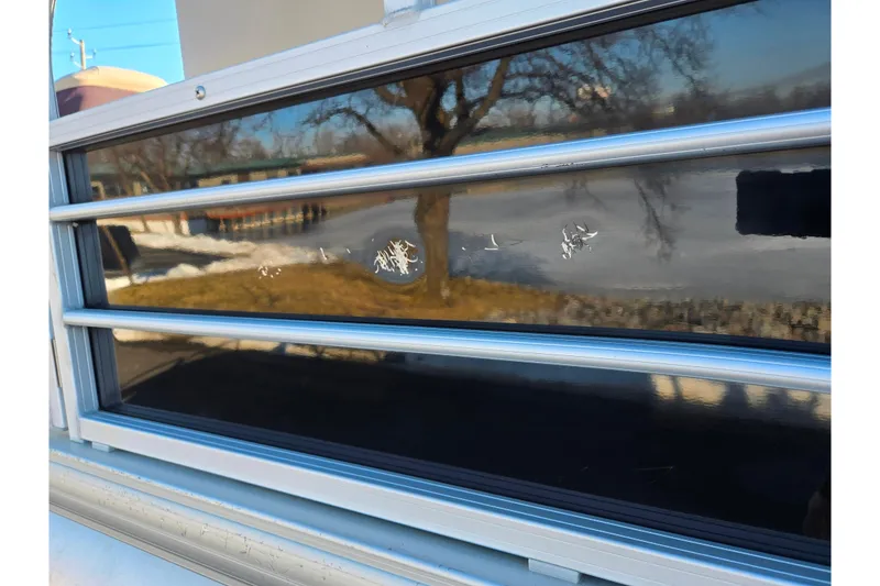 Slide: The Image of 2018 Sun Tracker Fishin' Barge 20 DLX with reflective panel and minor surface damage. - 6
