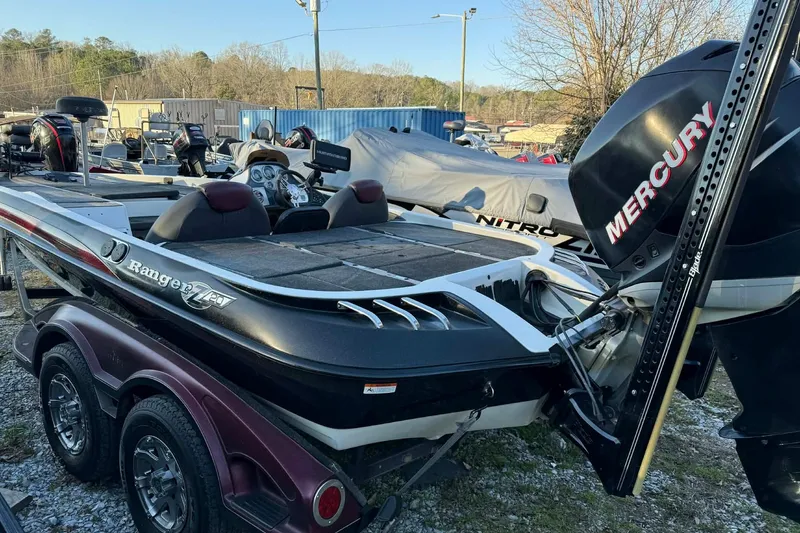 Slide: The Image of 2005 Ranger Z20 Comanche boat with Mercury engine in a parking lot. - 3