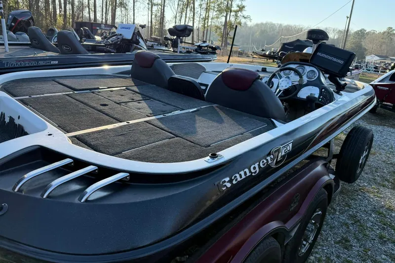 Slide: The Image of 2005 Ranger Z20 Comanche boat with dual seats and control panel, parked outdoors. - 6