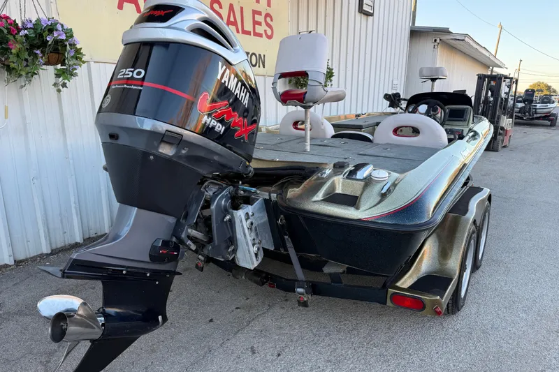 Slide: The Image of 2005 Bass Cat Puma boat with Yamaha VMAX 250 engine, parked outside a sales building. - 11