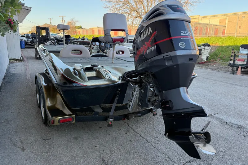 Slide: The Image of 2005 Bass Cat Puma boat with Yamaha VMAX 250 engine, parked outdoors. - 15