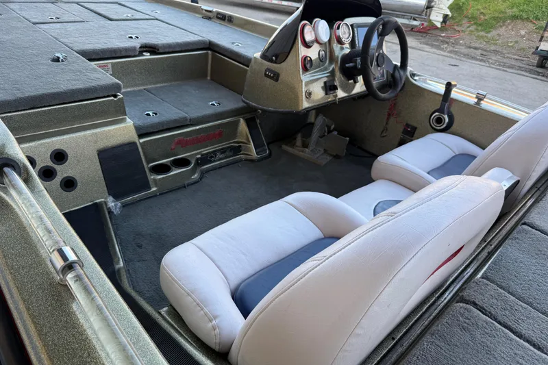 Slide: The Image of 2005 Bass Cat Puma boat interior with dual seats and dashboard controls. - 16