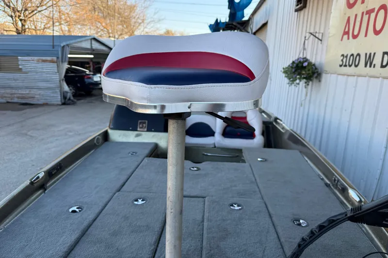 Slide: The Image of 2005 Bass Cat Puma boat interior with elevated seat and carpeted deck. - 23