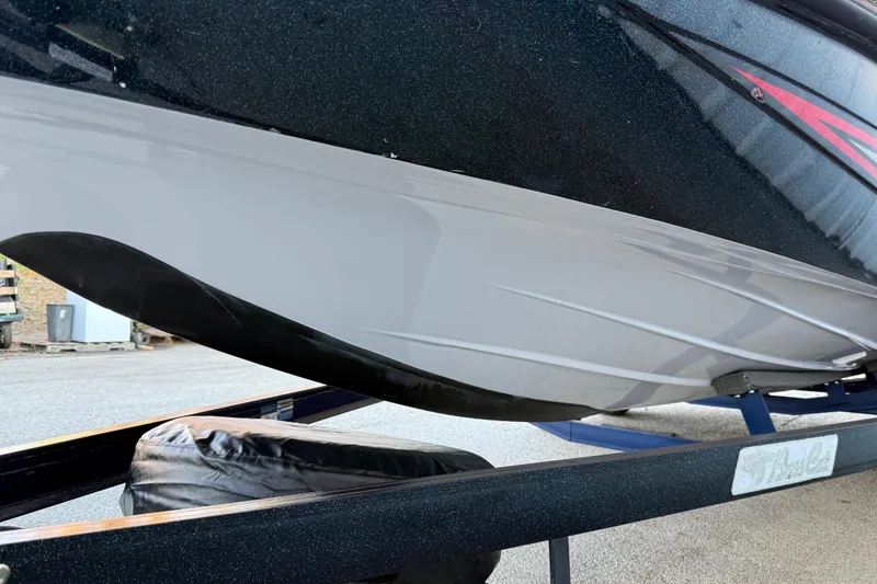 Slide: The Image of 2005 Bass Cat Puma boat hull on trailer, showcasing sleek design and detailing. - 32