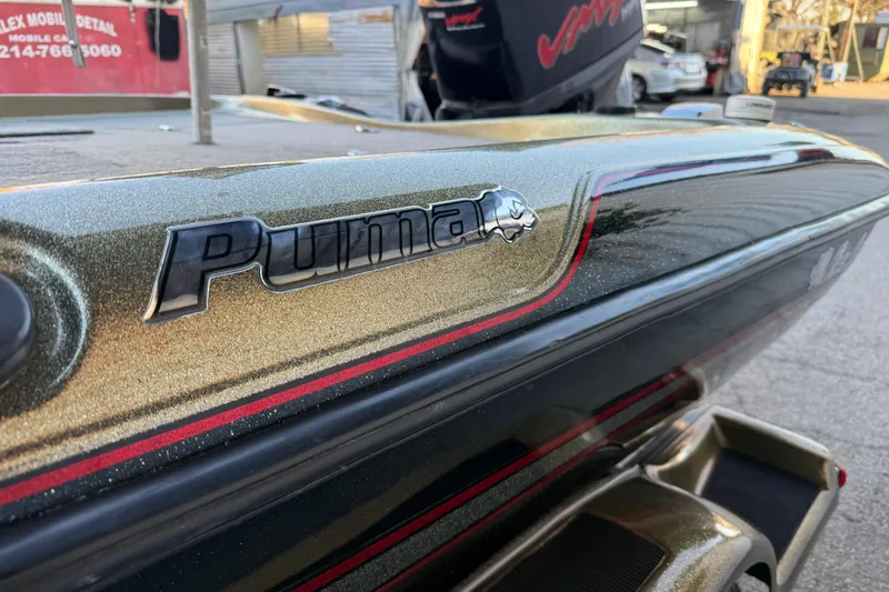 Slide: The Image of 2005 Bass Cat Puma boat with metallic finish and logo detail. - 33