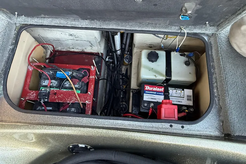Slide: The Image of 2005 Bass Cat Puma boat battery compartment with Duralast marine battery and wiring. - 35