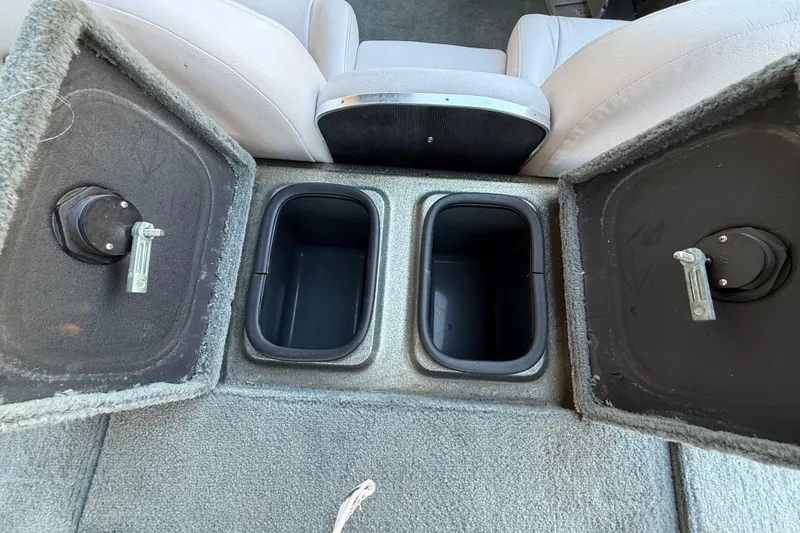 Slide: The Image of 2005 Bass Cat Puma boat storage compartments with open lids and seating. - 37