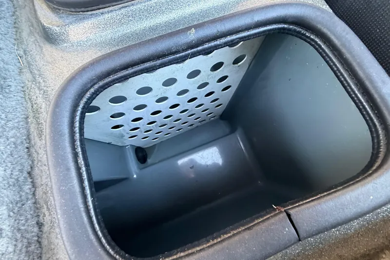 Slide: The Image of 2005 Bass Cat Puma boat compartment with perforated interior design. - 39