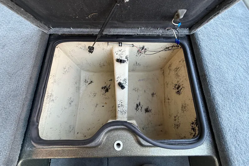 Slide: The Image of Open storage compartment in a 2005 Bass Cat Puma boat, showing interior details. - 46