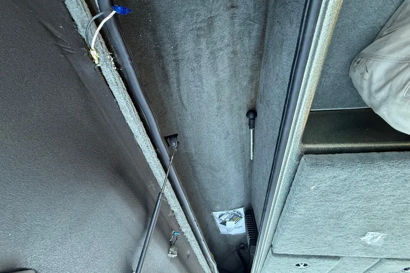 Slide: The Image of 2005 Bass Cat Puma boat interior storage compartment with carpeted finish. - 47