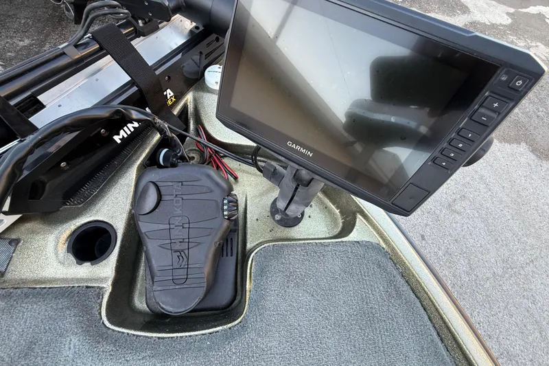 Slide: The Image of 2005 Bass Cat Puma boat dashboard with Garmin display and Minn Kota foot pedal. - 52