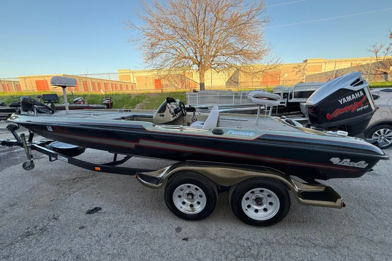 Slide: The Image of 2005 Bass Cat Puma boat with Yamaha engine on a trailer, parked outdoors. - 57