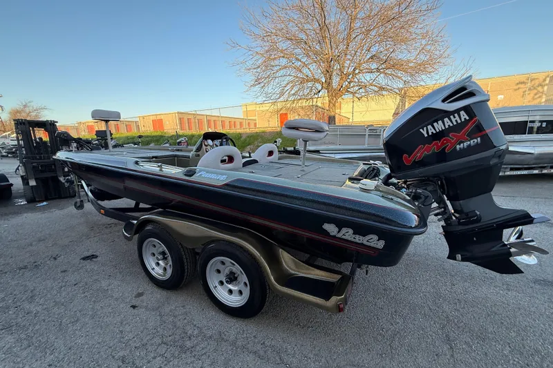 Slide: The Image of 2005 Bass Cat Puma boat with Yamaha VMAX engine, parked outdoors. - 58