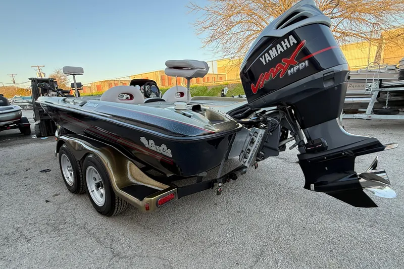 Slide: The Image of 2005 Bass Cat Puma boat with Yamaha VMAX engine, parked outdoors. - 59