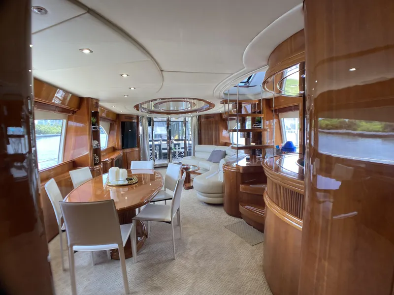 Slide: The Image of Luxurious interior of a 1999 Azimut 85 Ultimate yacht with elegant dining area and seating. - 11
