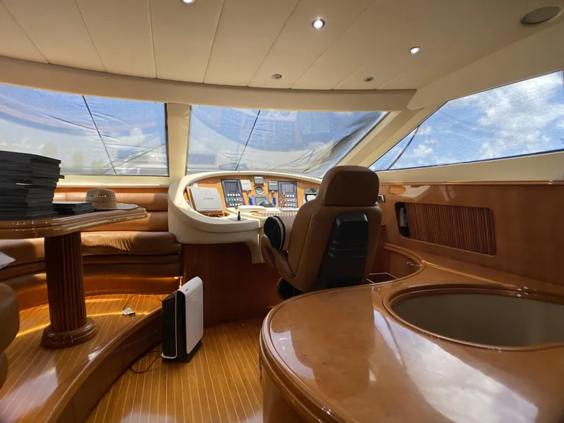 Slide: The Image of Luxurious dining area on 1999 Azimut 85 Ultimate yacht with elegant wooden table and white chairs. - 22