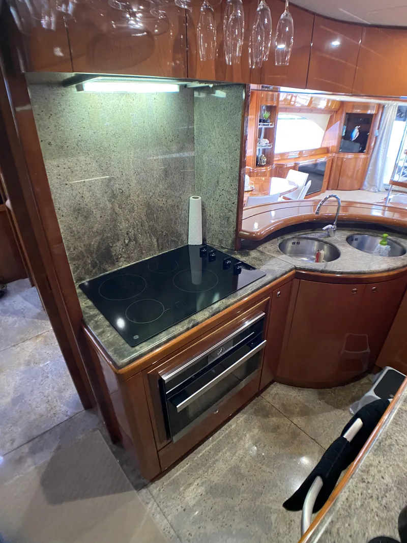 Slide: The Image of 1999 Azimut 85 Ultimate yacht kitchen with modern appliances and wooden cabinetry. - 25