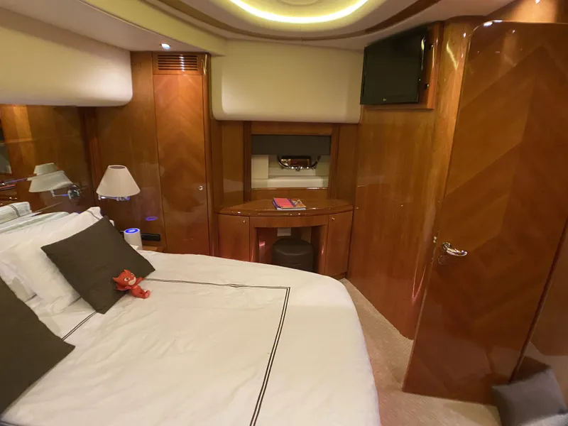 Slide: The Image of Luxurious bedroom interior of a 1999 Azimut 85 Ultimate yacht with elegant wood paneling. - 45