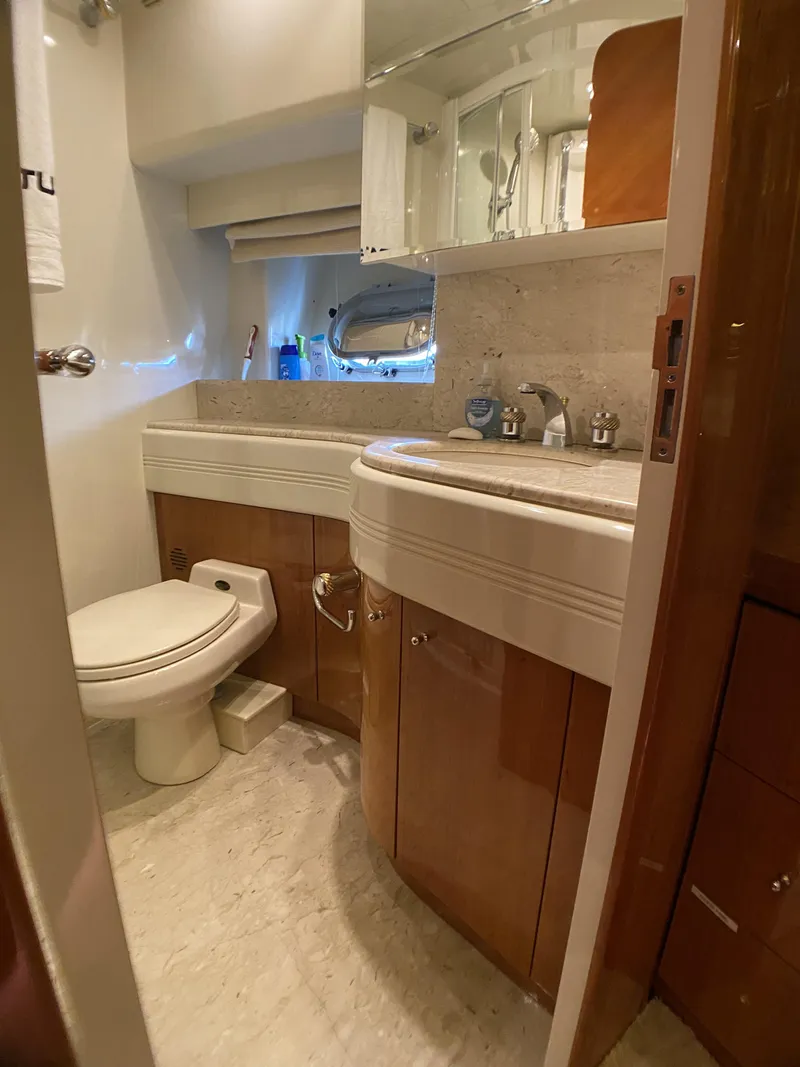 Slide: The Image of Luxurious bedroom interior of 1999 Azimut 85 Ultimate yacht with elegant wood finish. - 48