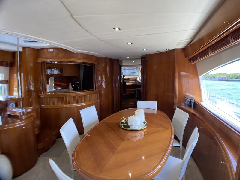 Slide: The Image of Luxurious interior of a 1999 Azimut 85 Ultimate yacht with elegant wood finishes and plush seating. - 6