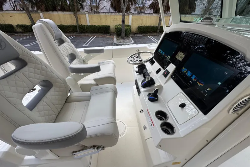 Slide: The Image of Luxurious interior of 2026 Sailfish 312 CC boat with advanced control panel and plush seating. - 10