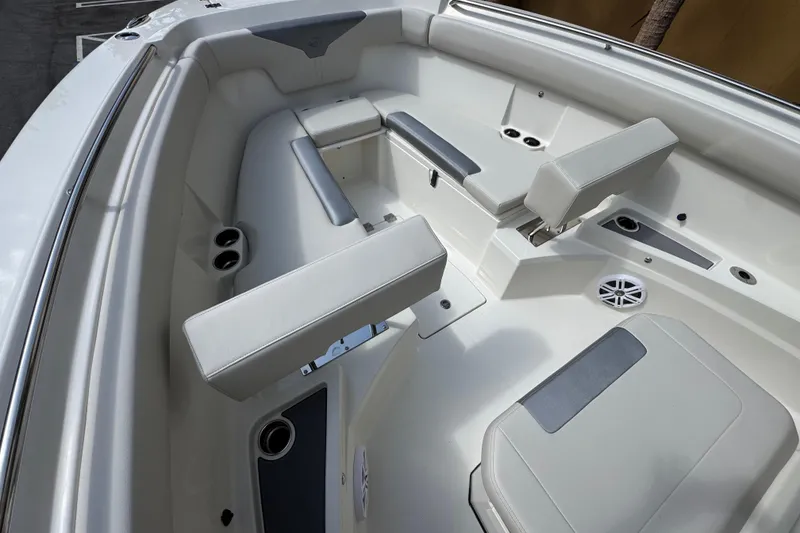 Slide: The Image of 2026 Sailfish 312 CC boat interior with cushioned seating and cup holders. - 20