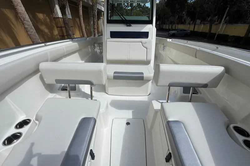 Slide: The Image of 2026 Sailfish 312 CC boat interior with white seating and cup holders. - 21