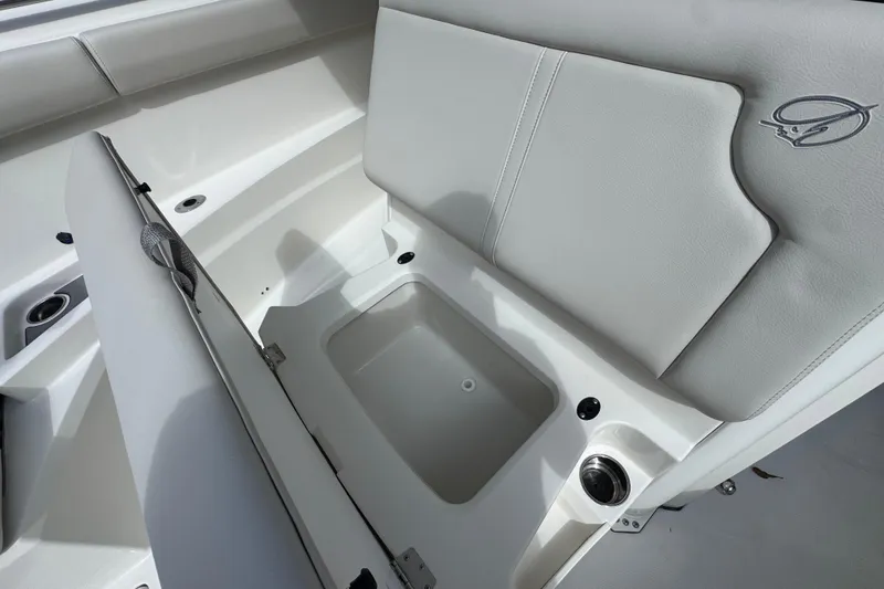 Slide: The Image of 2026 Sailfish 312 CC boat interior with storage compartment and cushioned seating. - 23