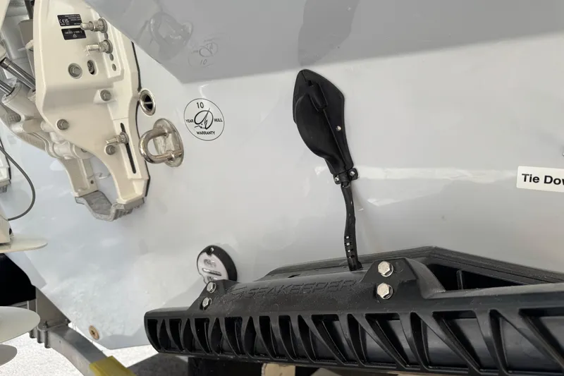 Slide: The Image of 2026 Sailfish 312 CC boat hull with warranty sticker and tie-down feature. - 24