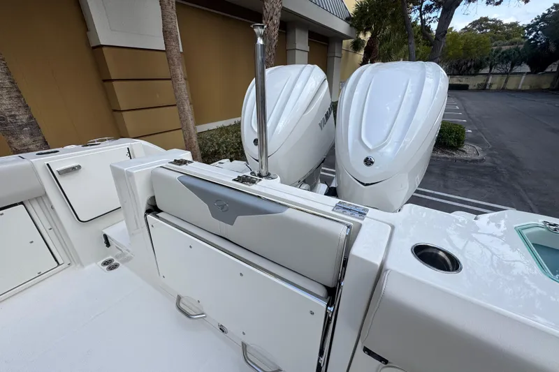 Slide: The Image of 2026 Sailfish 312 CC boat with dual outboard engines in a parking area. - 5