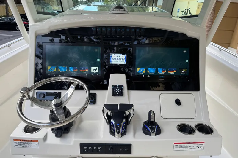 Slide: The Image of 2026 Sailfish 312 CC boat dashboard with dual screens and modern controls. - 8