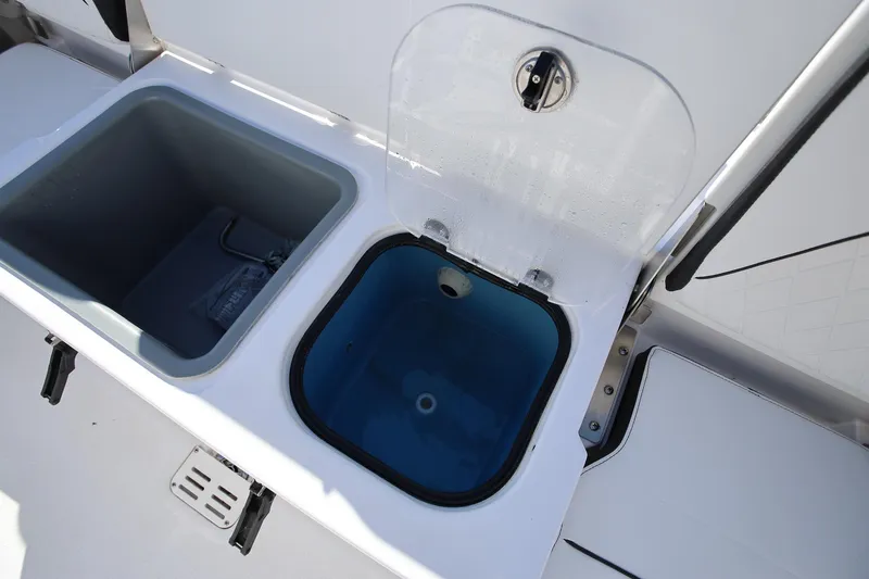 Slide: The Image of 2025 Stingray 173 CC boat storage compartments with open lids, showcasing interior design. - 10
