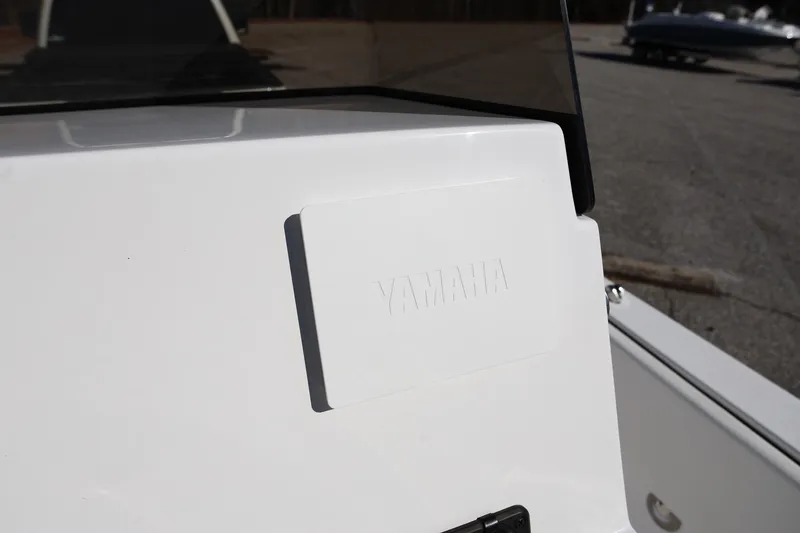 Slide: The Image of 2025 Stingray 173 CC boat console with Yamaha branding in a parking area. - 17
