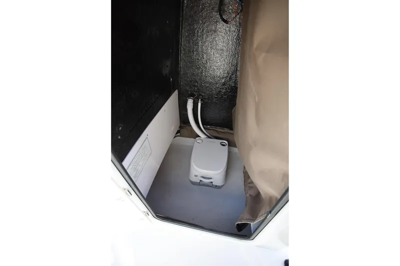 Slide: The Image of Interior view of 2025 Stingray 173 CC boat compartment with storage and wiring. - 19